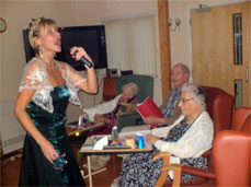 Residents are entertained by one of our visiting artists.