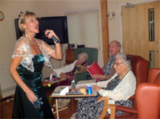 Residents are entertained by one of our visiting artists. Residents are entertained by one of our visiting artists.